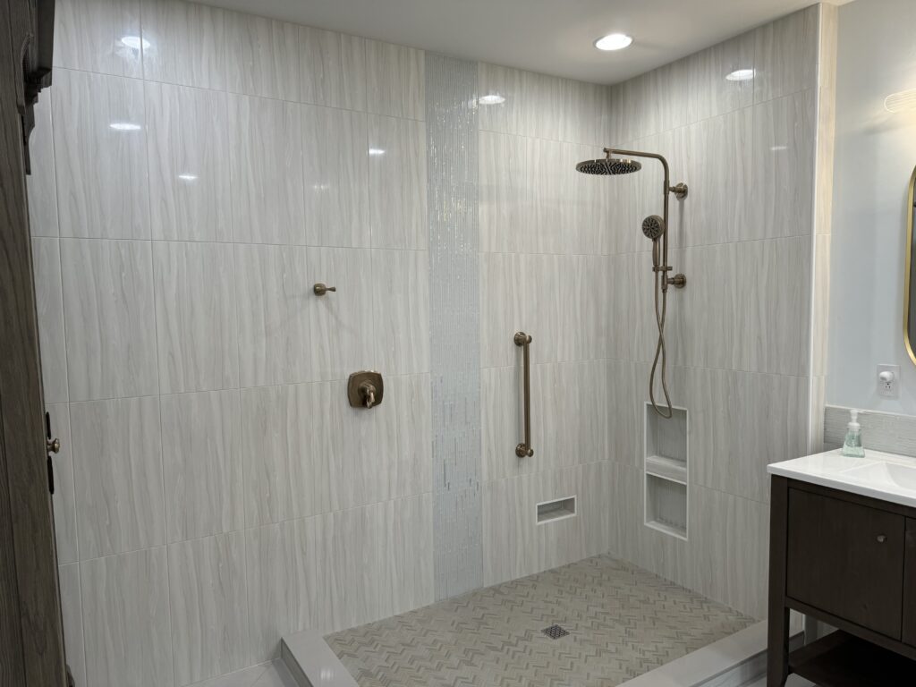 This image features a curbless shower with grey tile. 