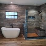 bathroom with walk-in shower and freestanding tub