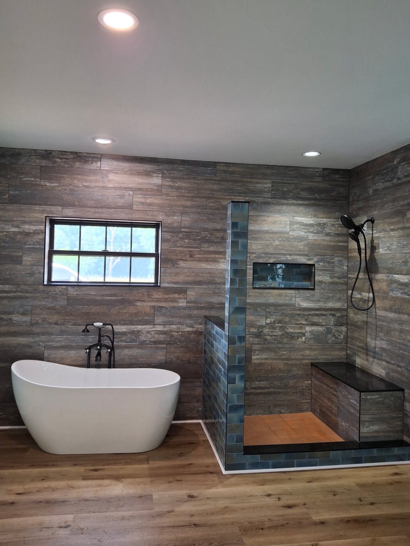 bathroom with walk-in shower and freestanding tub